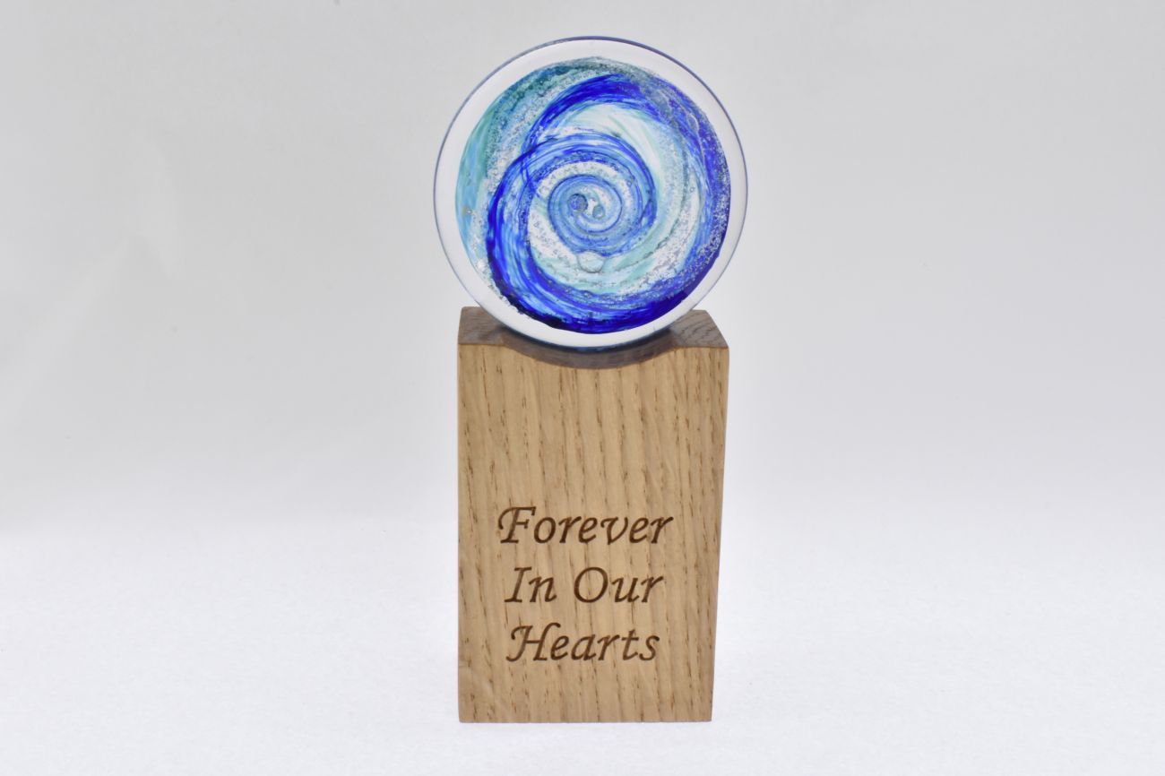 Remembrance Glass Disk with Encased Ashes on Wooden Base.
